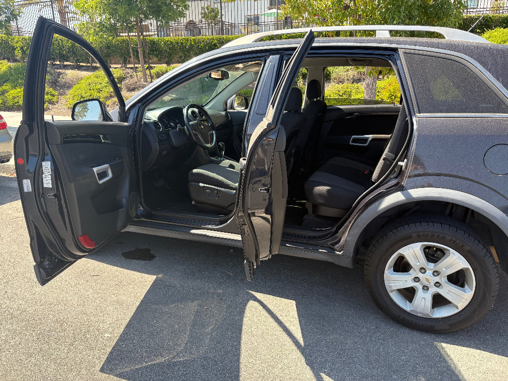 Gray SUV with doors open in a parking lot