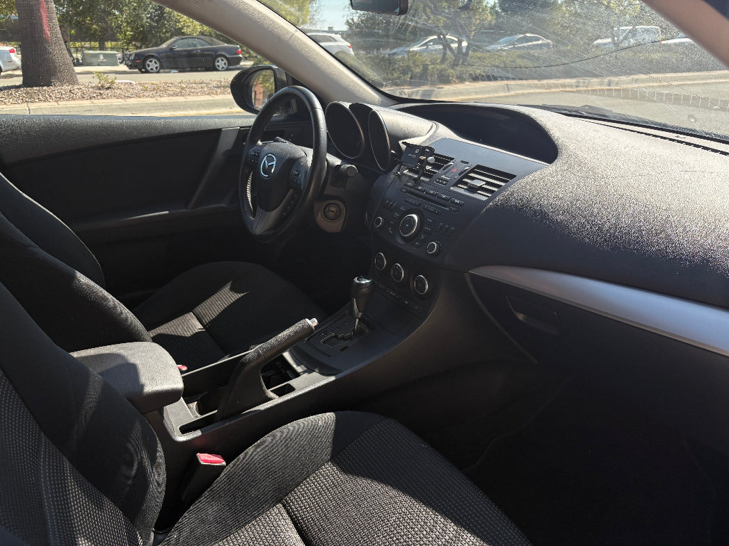 Car interior with steering wheel and dashboard view