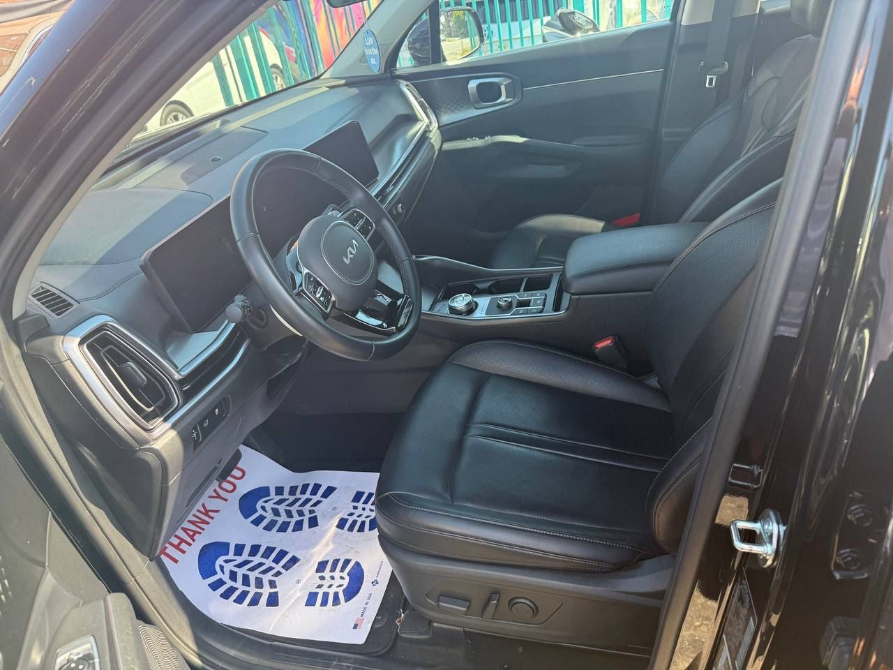SUV for rent interior with a 'Thank You' mat on the floor
