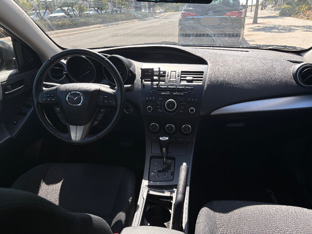 Car interior with steering wheel and dashboard view