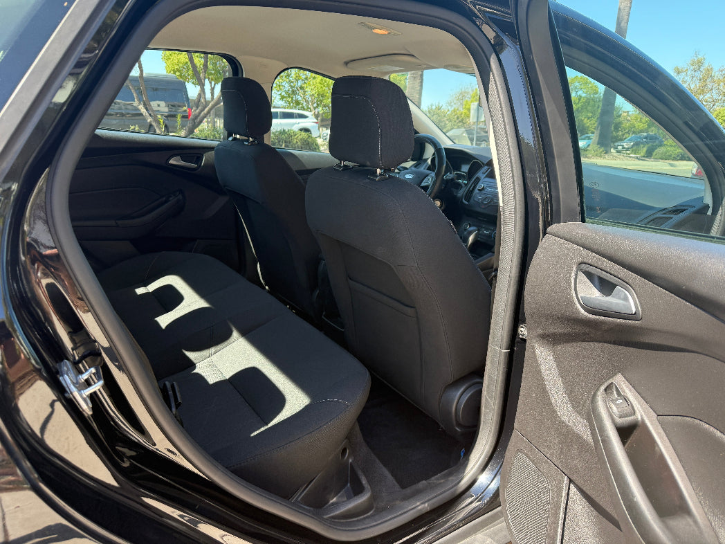 Car interior with black seat covers on gray seats