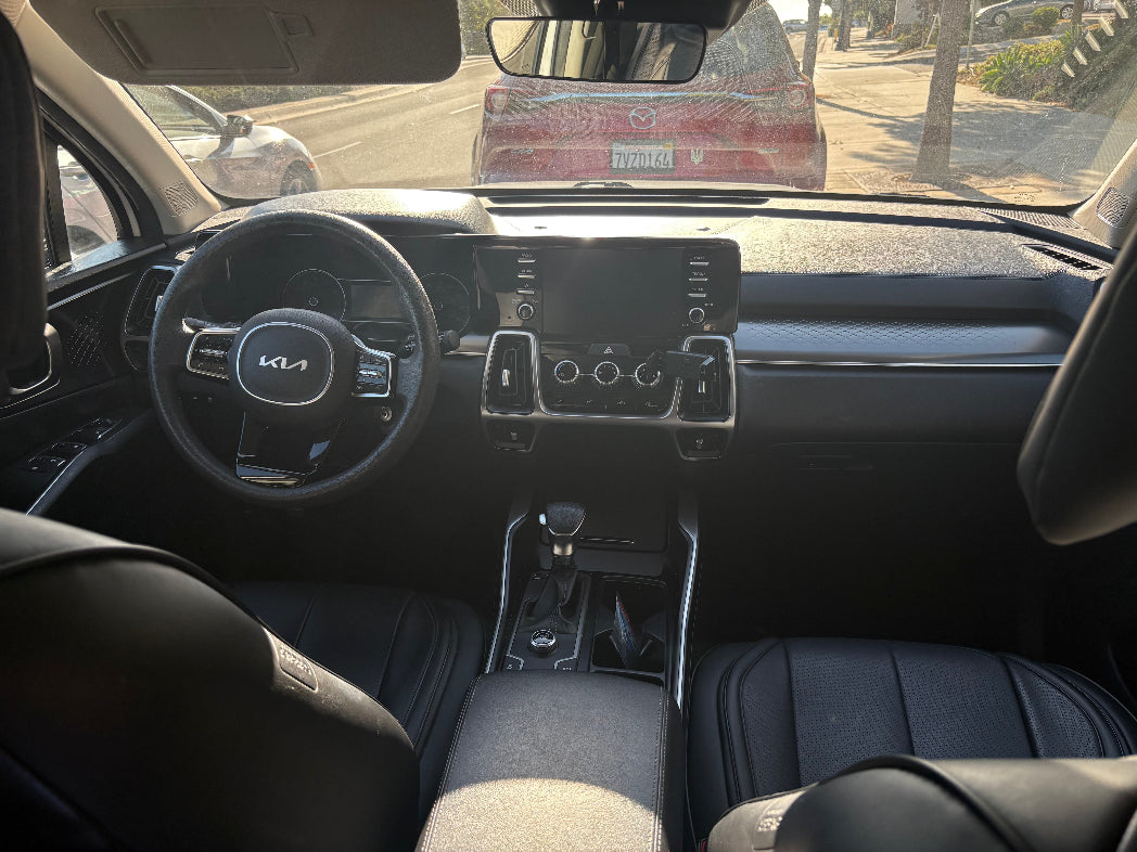 Car interior with steering wheel and dashboard view
