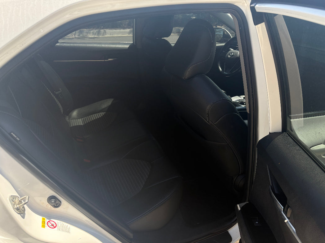 Car interior with a focus on the driver's seat and dashboard.