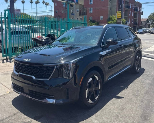 Kia Sorrento SUV for rent parked on a San Diego street with buildings and cars in the background