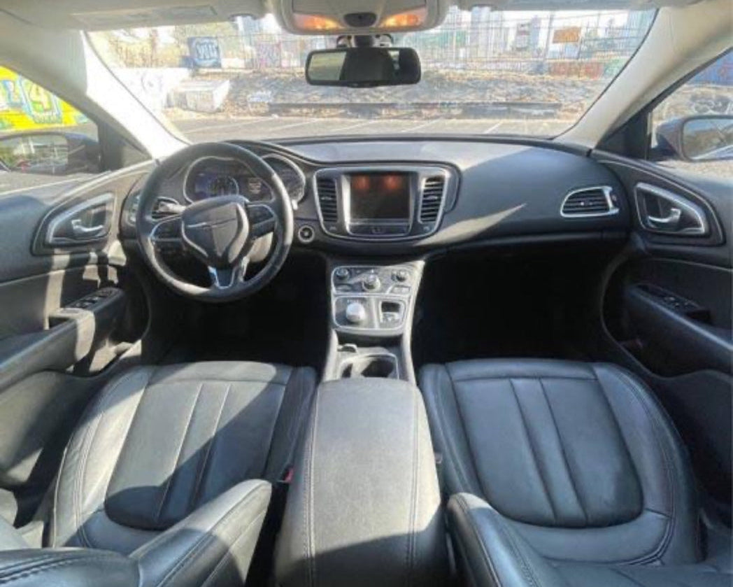Car interior with dashboard, steering wheel, and seats.