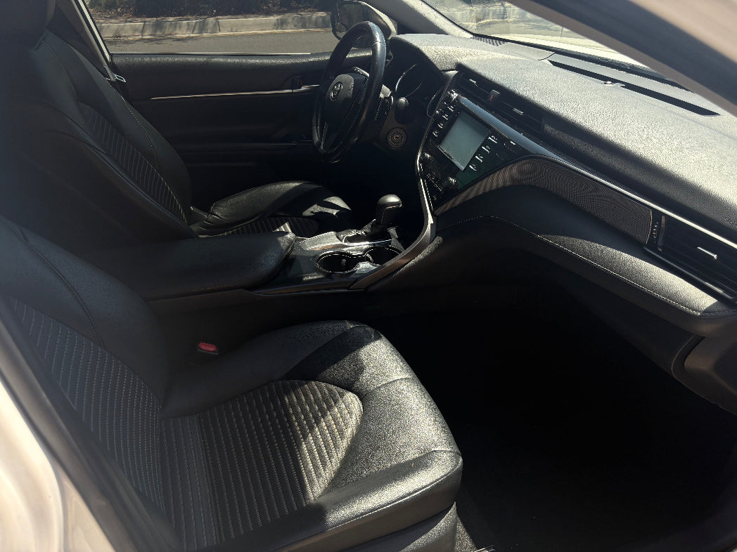 Car interior with steering wheel and dashboard visible