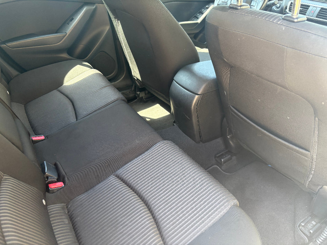 Back seat of a car with gray upholstery